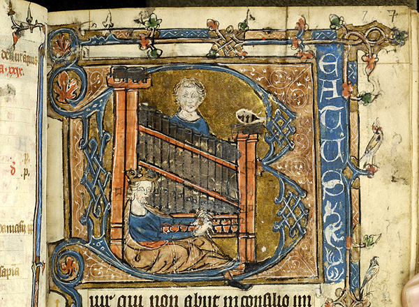 King David sitting on the floor, playing the organ